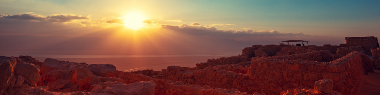 Beautiful sunrise over the Dead Sea. View from Masada fortress. Ruins of King Herod's palace in Judaean Desert
