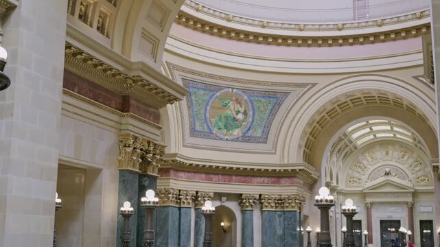 Cinematic gimbal dolly left shot inside Wisconsin State Capitol featuring lights and rotunda with smooth stabilized camera movement.
