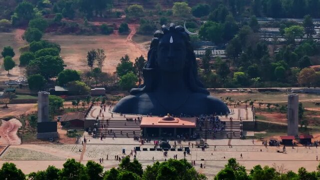 Adiyogi Shiva statue with Shri Yogeshwara Linga Gudi and tourist at Isha Foundation Chikkaballapura, Avalagurki, Karnataka, india. day time, trucking shot, drone shot, 4k.