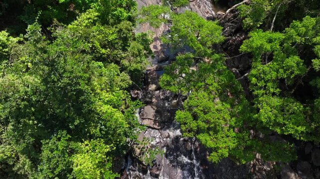 Surlabbi Waterfalls with trees and rocky terrain at Coorg, Kodagu, Karnataka, india. day time, top down shot, push in shot, drone shot, 4k.