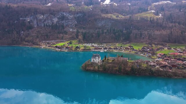 Orbitshot with Drone of Iseltwald in Canton Bern at the Lake Brienzersee during Spring