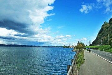 Obraz premium Switzerland - cyclist on the path and church in Berlingen