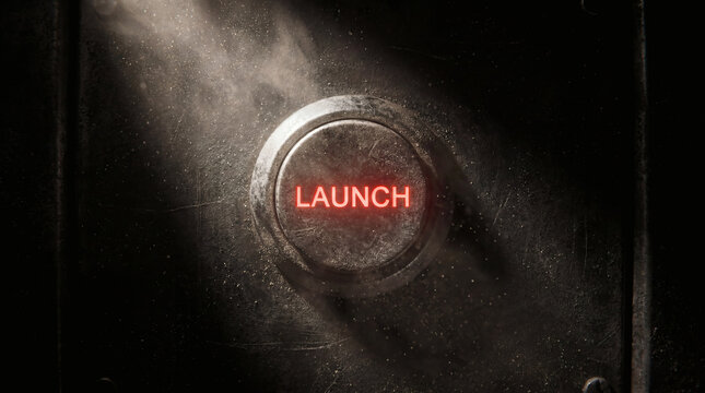 Glowing Red Launch Button on Grungy Industrial Metal Surface