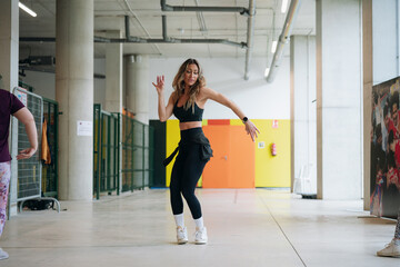 Naklejka premium Woman dancing actively during indoor fitness workout session