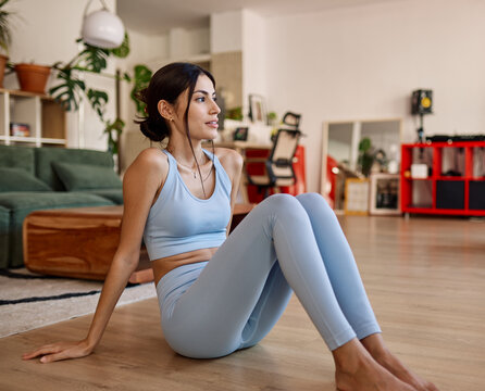 Portrait of a young latina woman posing with mat in sportswear prepering to exercise at home gym