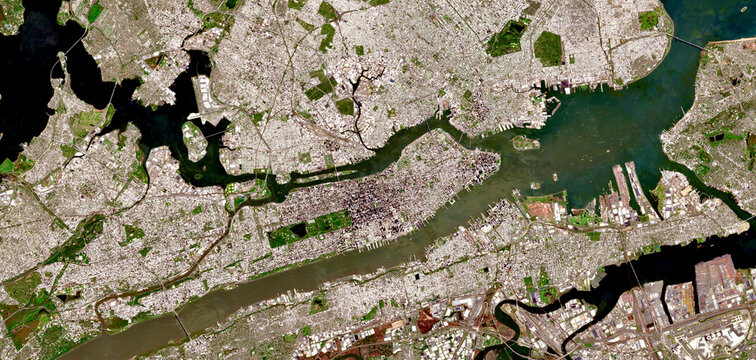 Aerial satellite view of New York City, Manhattan and surrounding boroughs with visible urban grid, rivers, bridges and coastal landscape in the USA
