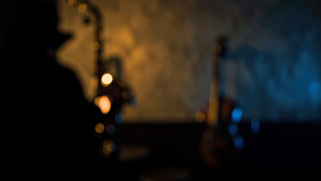 Musician silhouette playing instruments in a warm moody jazz club