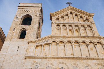 Fototapeta premium Cagliari Cathedral facade, bell tower, and entrance in Sardinia, Italy, displaying intricate Romanesque architectural details