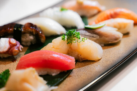Premium assorted sushi nigiri platter with scallop sushi in focus