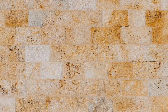 Limestone brick wall texture background in Cagliari, Sardinia, Italy, showing old masonry and natural stone surface