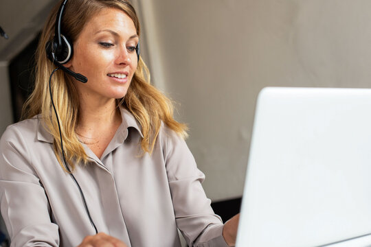 Woman working remotely with headset