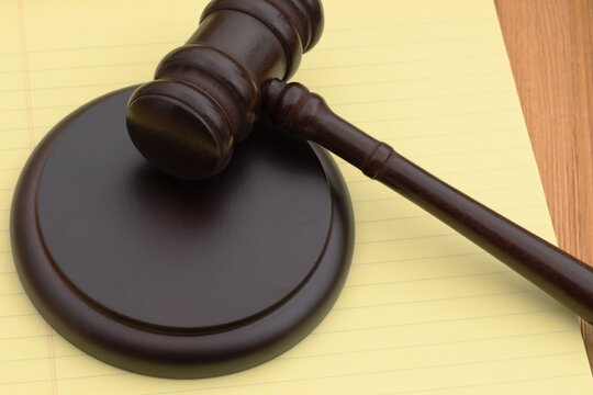 Judge gavel and block on legal pad for legal authority
