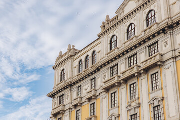 Obraz premium Cagliari, Sardinia, Italy. Historic facade with ornate balconies, windows, and traditional architecture under a cloudy sky
