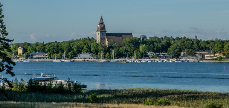 The harbour and waterfront of Naantali town in south-west Finland during a sunny summer day. The  medieval stone church was built in 1480.