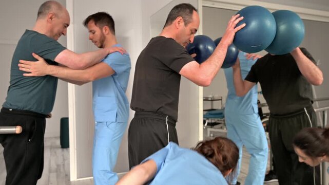 Patients with cerebral palsy performing mobility exercises in physiotherapy clinic. Rehabilitation session focused on movement, balance, coordination and functional recovery. High quality 4k footage