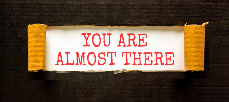You are almost there words symbol. Concept words You are almost there on beautiful white paper. Beautiful black background. Business You are almost there motivational support concept. Copy space.