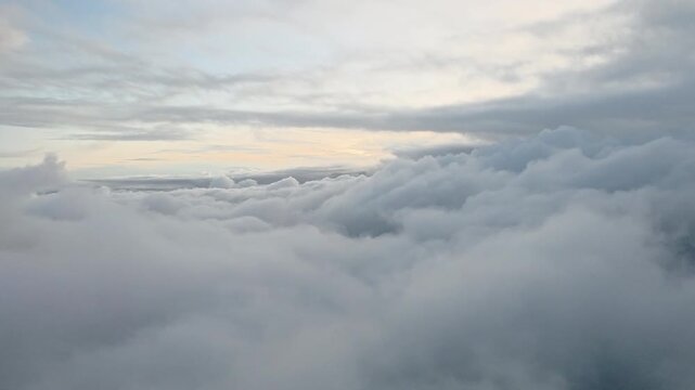 Cloud inversion layer over Taiwan, East Asia shows stratocumulus cloud deck trapped below stable boundary layer with overcast upper cloud formation during low solar radiation conditions, aerial static