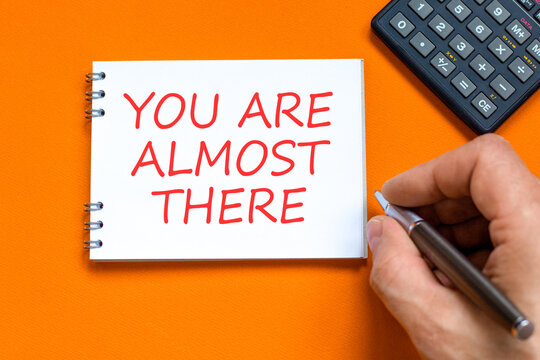 You are almost there words symbol. Concept words You are almost there on beautiful white note. Beautiful orange background. Business You are almost there motivational support concept. Copy space.