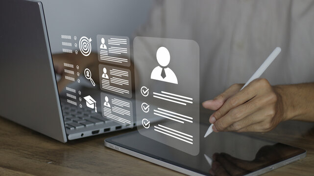 HR and recruitment concept focusing on digital candidate screening using a laptop and tablet. Features icons for education, skills, and profile verification for modern hiring efficiency