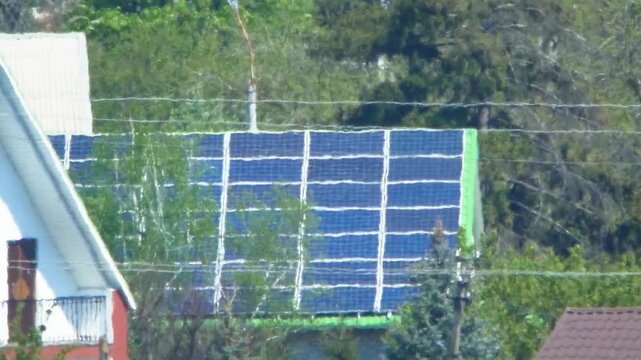 Solar panels on roof of suburban house during summer heat. Atmospheric distortion and shimmering air illustrate climate change, renewable energy transition, global warming, environmental stress
