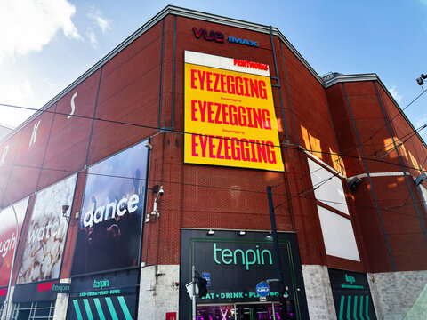 Tenpin bowling and Vue IMAX advertising on a large red brick  Printworks entertainment complex in Manchester, UK