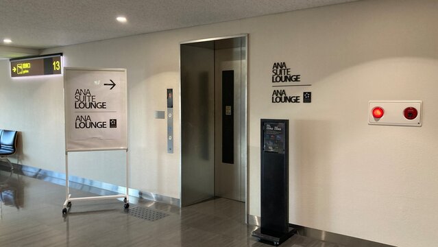 ANA Suite Lounge and ANA Lounge entrance signage with terminal elevator and airport gate 13 directory at Osaka Itami International Airport - Osaka, Japan, January 29, 2024