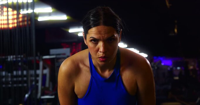 Slow Motion Of Focused Woman Training On Cardio Machine In Modern Gym, Intense Workout And Mental Strength Concept
