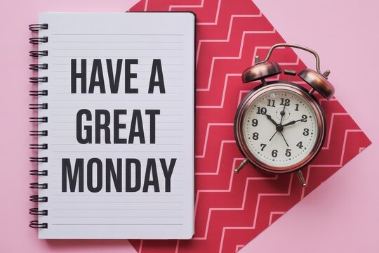 Have a Great Monday Written on Spiral Notebook with Vintage Alarm Clock Flat Lay