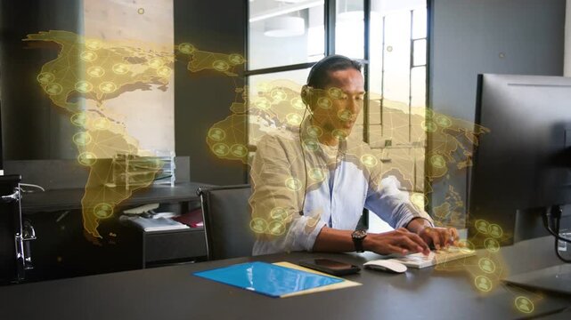 Man starting typing, alternating mouse use and gesturing, tech analyzing global network overlay