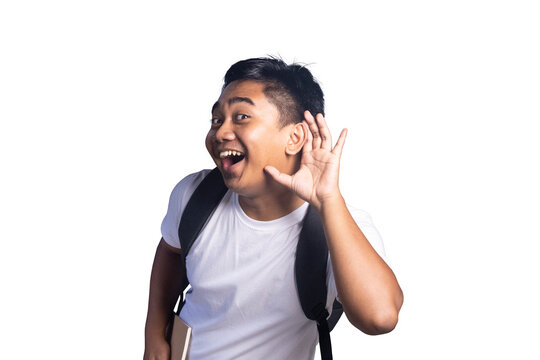 Young man wearing a backpack holding a hand to his ear as if listening or eavesdropping with a happy and excited facial expression. white background.