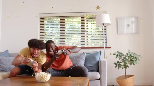 Two male friends pressing gamepads and leaning on sofa reacting to gaming win, gold stars drifting