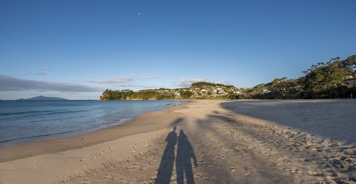 Shadow of two persons, couple on the beach, Langs Beach, Northland, North Island, New Zealand