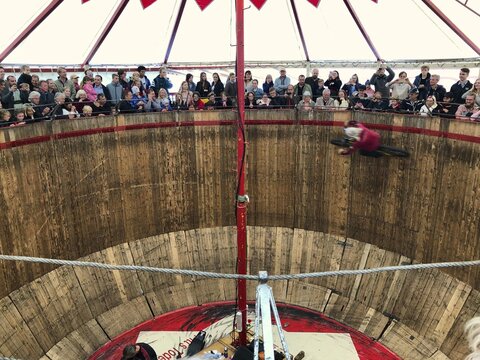 Spectators look down on motorcyclists on a steep wooden wall, Pitt's wall of death, attraction, showmen at Oktoberfest, Munich, Bavaria, Germany