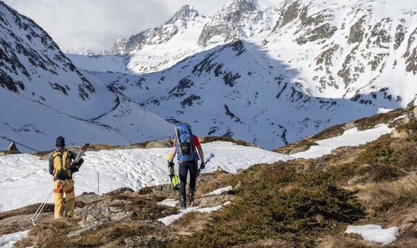 Ski tourers in winter in the mountains, carrying skis, Oberbergtal, Neustift im Stubai Valley, Tyrol, Austria