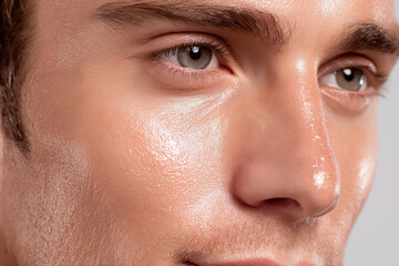 Fototapeta premium Hydrated male skin smooth texture close up natural skin glow healthy complexion radiant pores facial detail