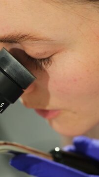 Doctor examines cervix through colposcope during Pap test check. Specialist keeps steady focus reviewing surface details carefully
