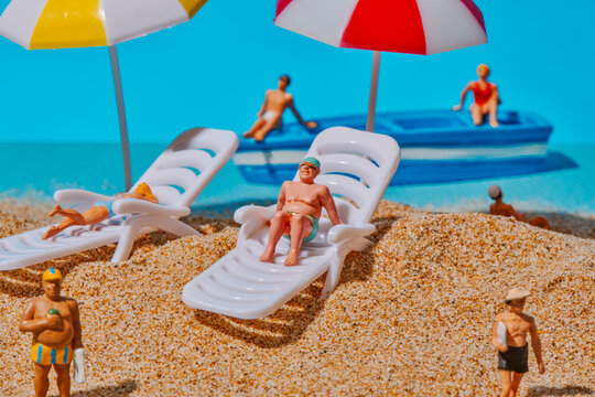 miniature people enjoying a day on the beach
