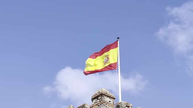Bandera de Espa&ntilde;a bajo el sol con cielo despejado