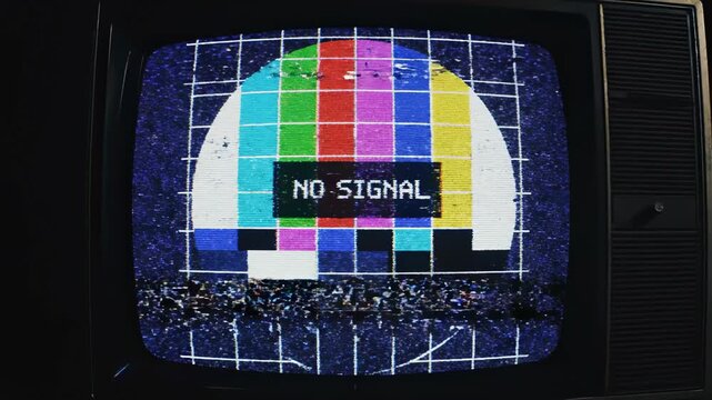 Retro television screen with no signal message and colorful test pattern glitch effect.