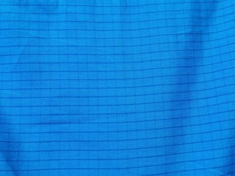Close-up Texture of Blue Ripstop Nylon Fabric with a Durable Grid Pattern