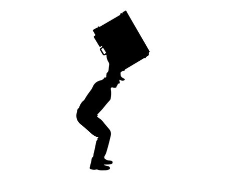 Silhouette of a man carrying a heavy box on his shoulder