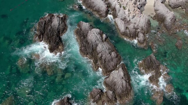 Drone on the rocks in the sea lagoon on a sunny day. Capo Vaticano in the Municipality of Ricadi in Calabria, Italy.