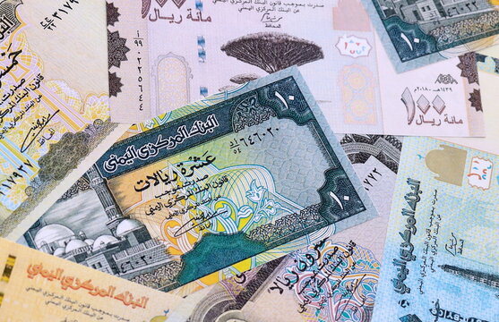 Yemeni rial money bills pile on table. Yemen banknotes of YER currency close up.