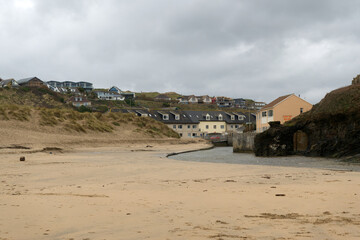 Obraz premium Perranporth seaside resort with sandy beach on a cloudy winter day. Photo taken February 2nd, 2026, Perranporth, Cornwall, United Kingdom.