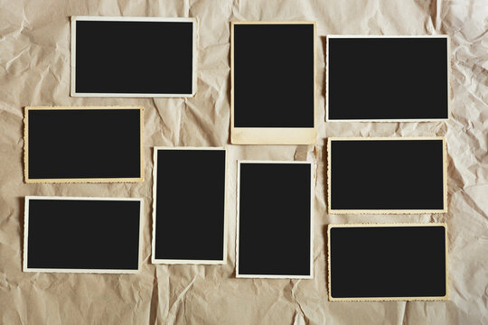 old empty photo frames, vintage blank photographic prints on wood with free space for pictures