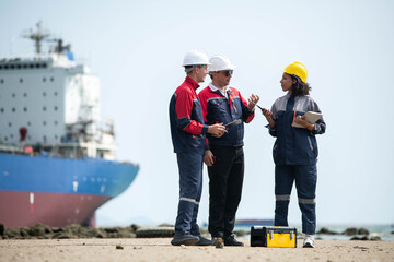 Fototapeta premium Port engineering team collaborating near cargo vessel and industrial shipping terminal
