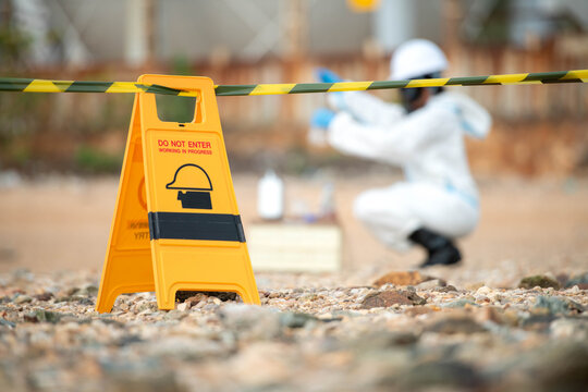 Hazmat technician collecting environmental samples inside restricted hazardous