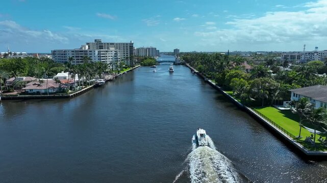 Drone overtaking a fast boat in the ICW as it approaches the drawbridge at Delray Beach Florida.
