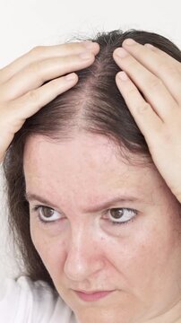Close up of woman controls hair loss at home