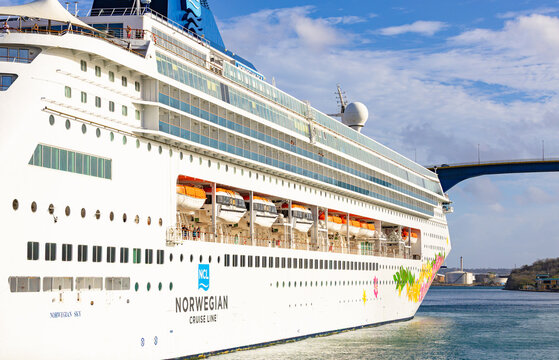Willemctad, Curacao - 22.03.2026: Norwegian Sky cruise ship with lifeboats and balconies docked at Willemstad harbor with Queen Juliana Bridge behind